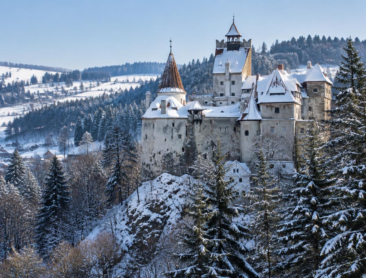 Bran Castle in winter surrounded by snowy fir forests